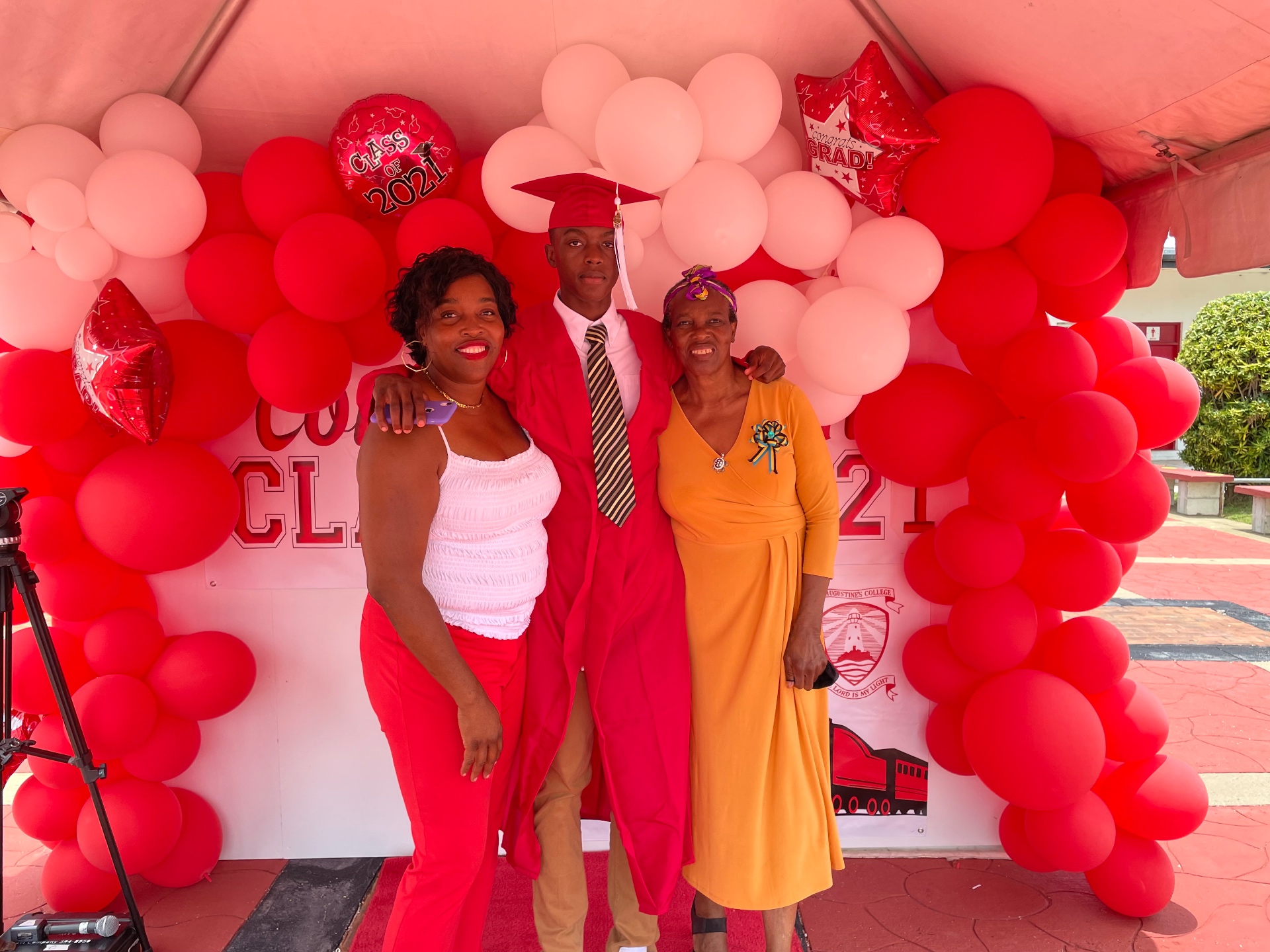 Rashawn at graduation with his mom and grandmother